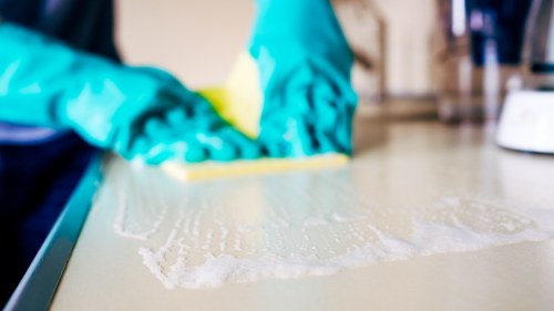 Cleaner working in a kitchen and bathroom in Shepherdsbush